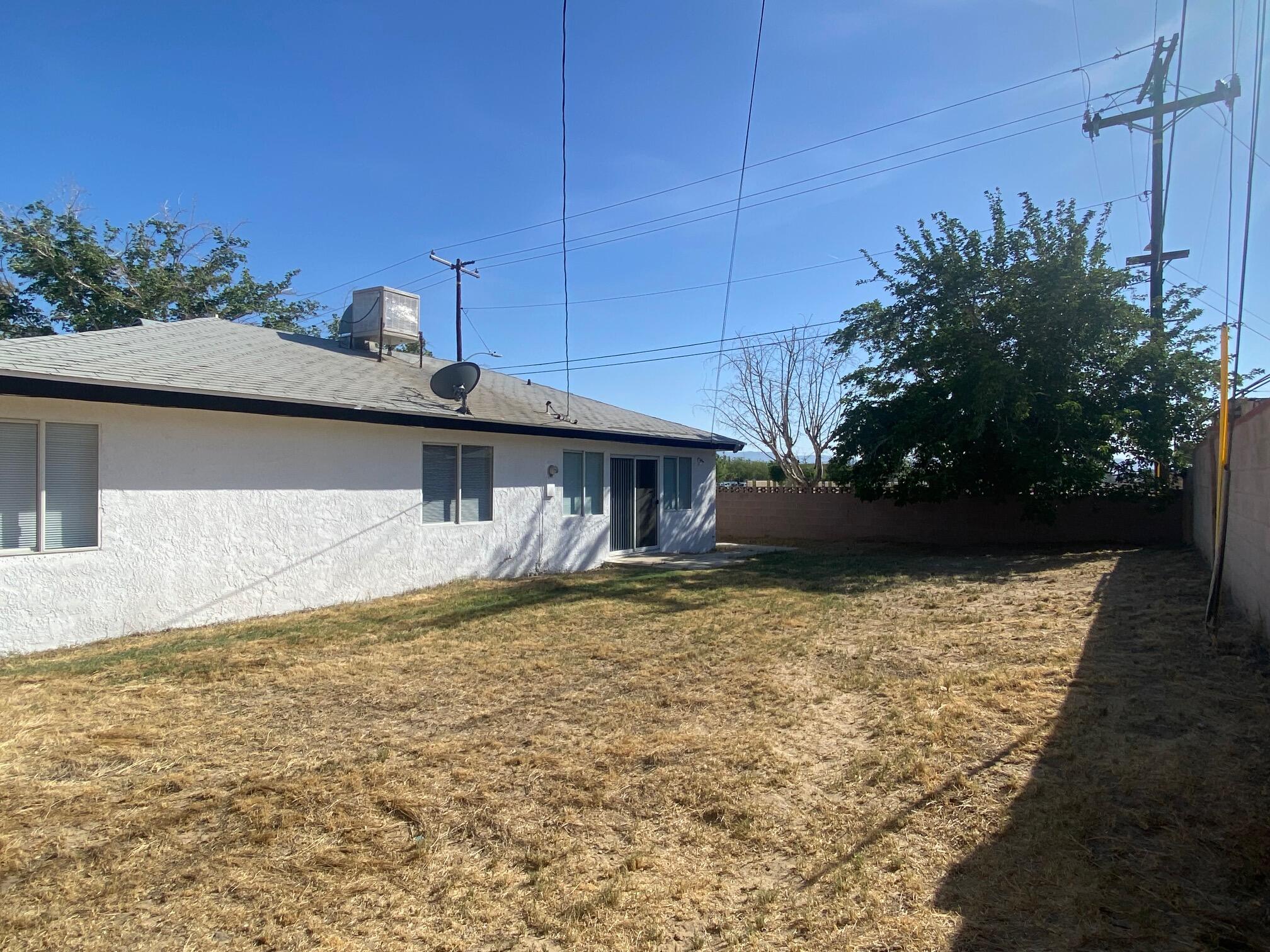 45325 Raysack Avenue Lancaster, CA 93535 - Photo 16 of 17 a view of a house with backyard and sitting area