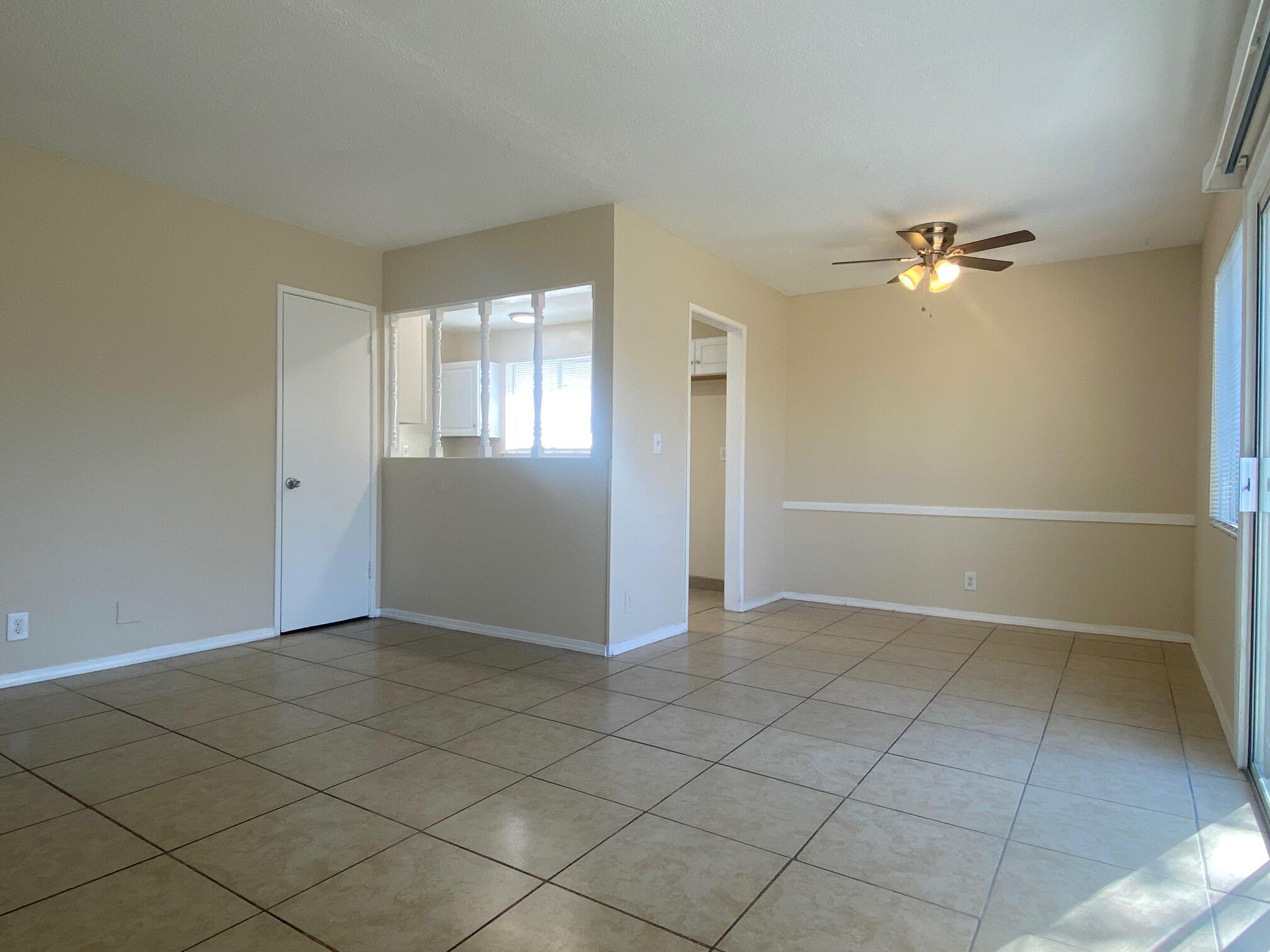 45325 Raysack Avenue Lancaster, CA 93535 - Photo 3 of 17 an empty room with windows and fan
