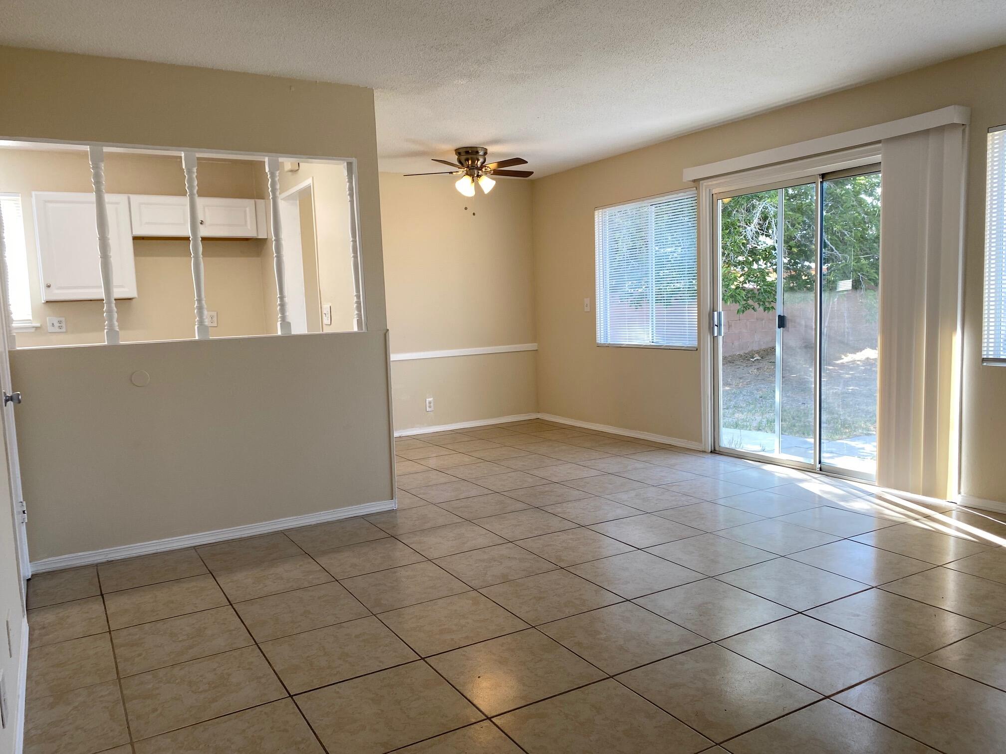 45325 Raysack Avenue Lancaster, CA 93535 - Photo 4 of 17 an empty room with windows and view of kitchen
