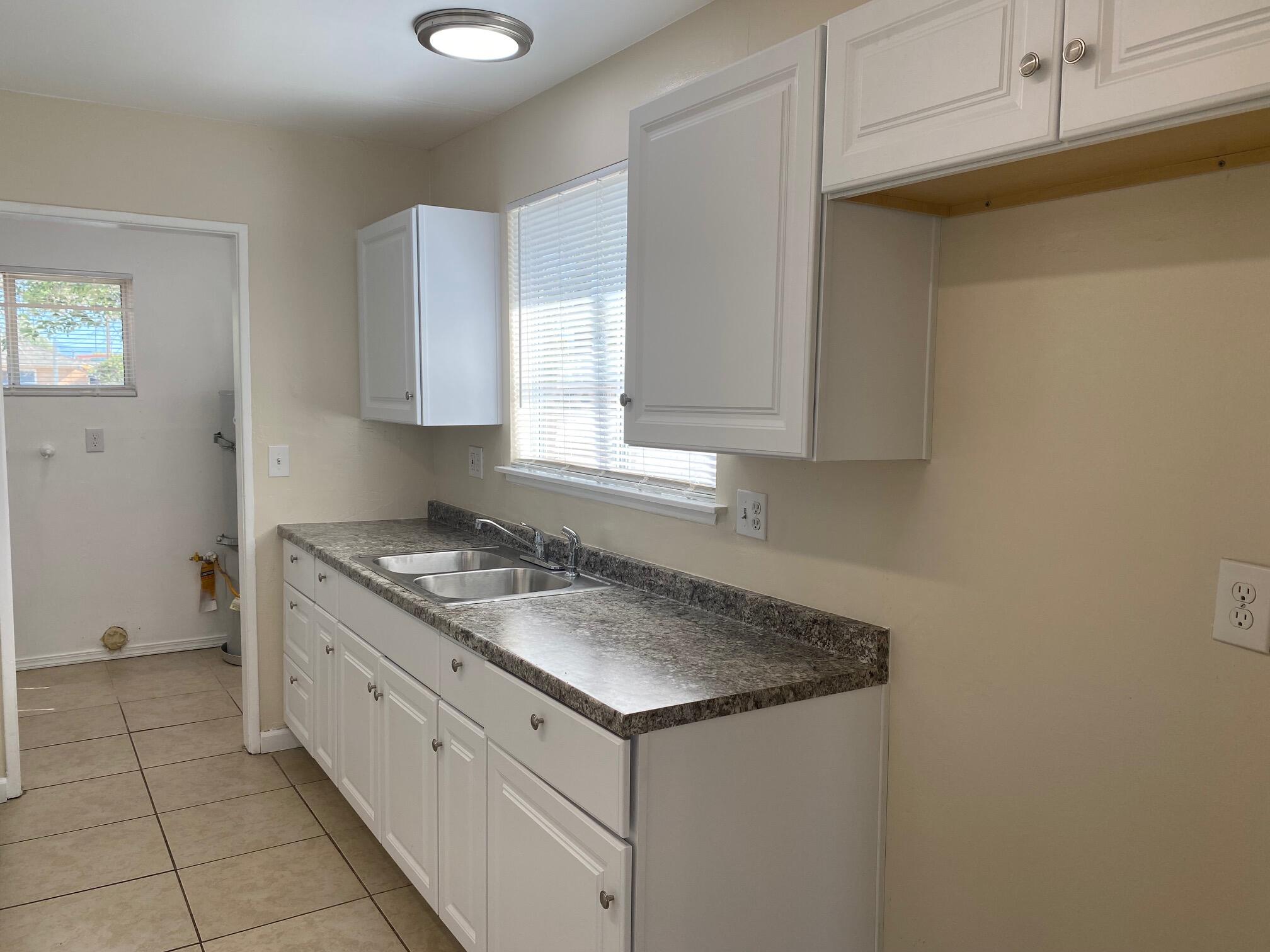45325 Raysack Avenue Lancaster, CA 93535 - Photo 7 of 17 a kitchen with a sink cabinets and a window
