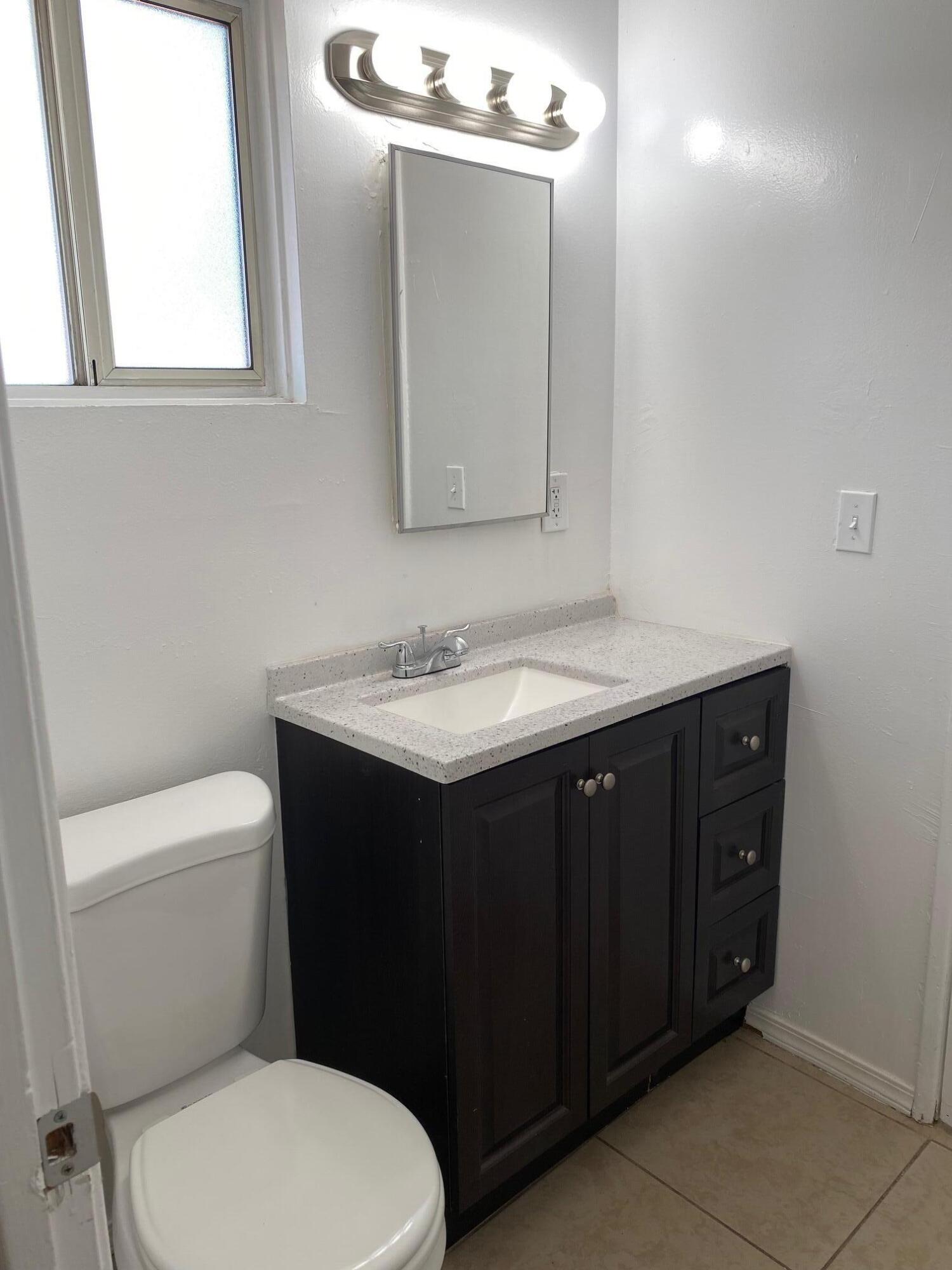 45325 Raysack Avenue Lancaster, CA 93535 - Photo 8 of 17 a bathroom with a sink vanity and a toilet