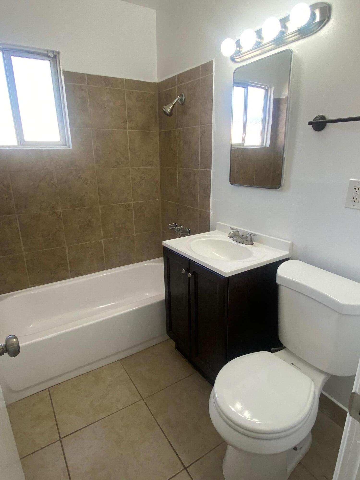 45325 Raysack Avenue Lancaster, CA 93535 - Photo 10 of 17 a bathroom with a sink a toilet and shower