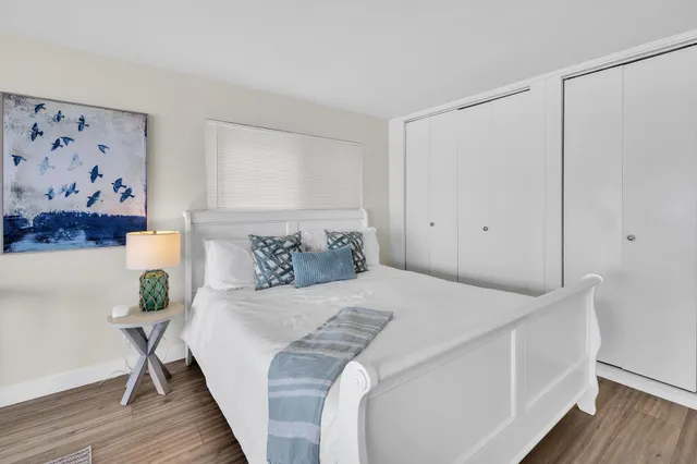 a bedroom with a bed and wooden floor