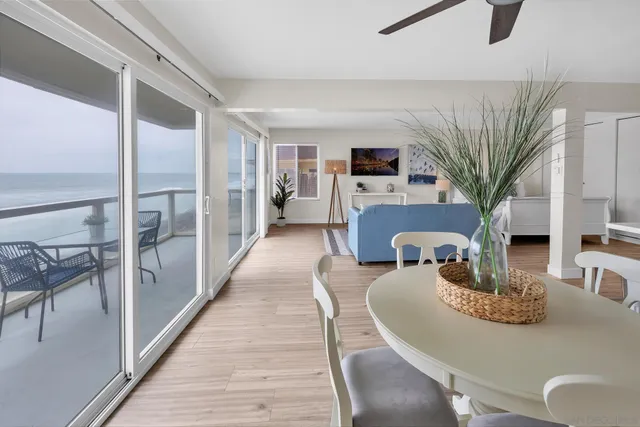 a dining room with furniture a rug a fireplace and wooden floor