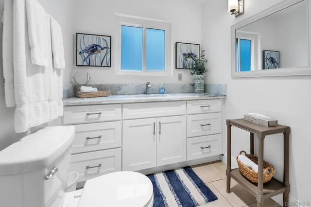 a bathroom with a toilet a sink and mirror