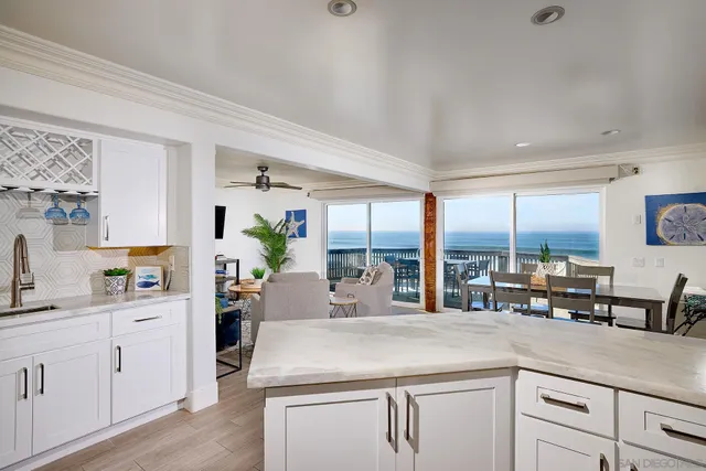 a kitchen with counter top space and living room