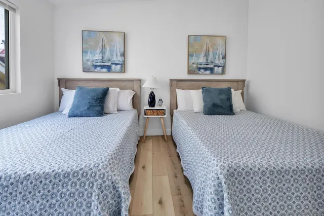 a bed room with a bed and painting on the wall