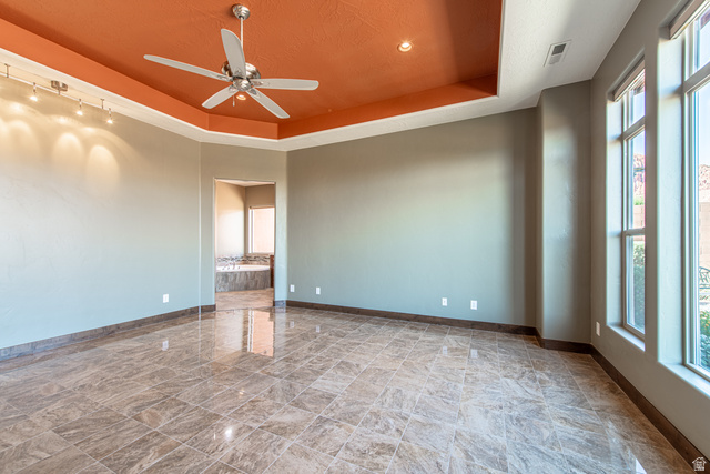 322 340 E Street Ivins, UT 84738 - Photo 26 of 61 Spacious interior room featuring polished tile flooring, a tiered ceiling with an orange accent, and a ceiling fan