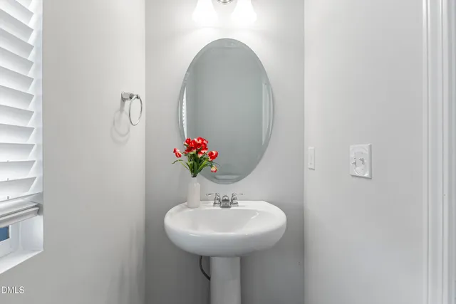 a bathroom with a sink vanity and mirror