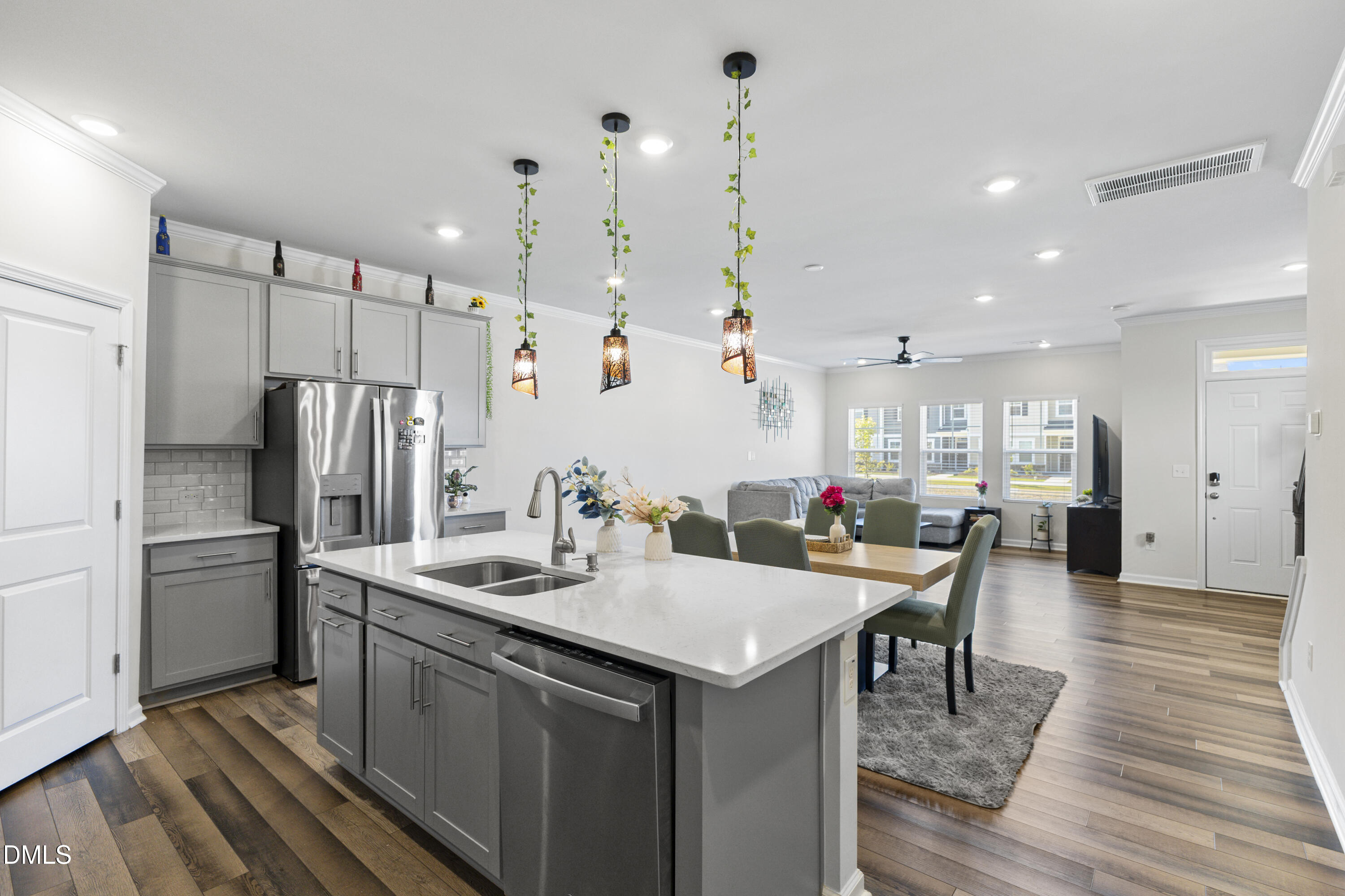 1811 Aspen River Lane Apex, NC 27502 - Photo 13 of 36 a kitchen with stainless steel appliances granite countertop a table chairs stove and refrigerator