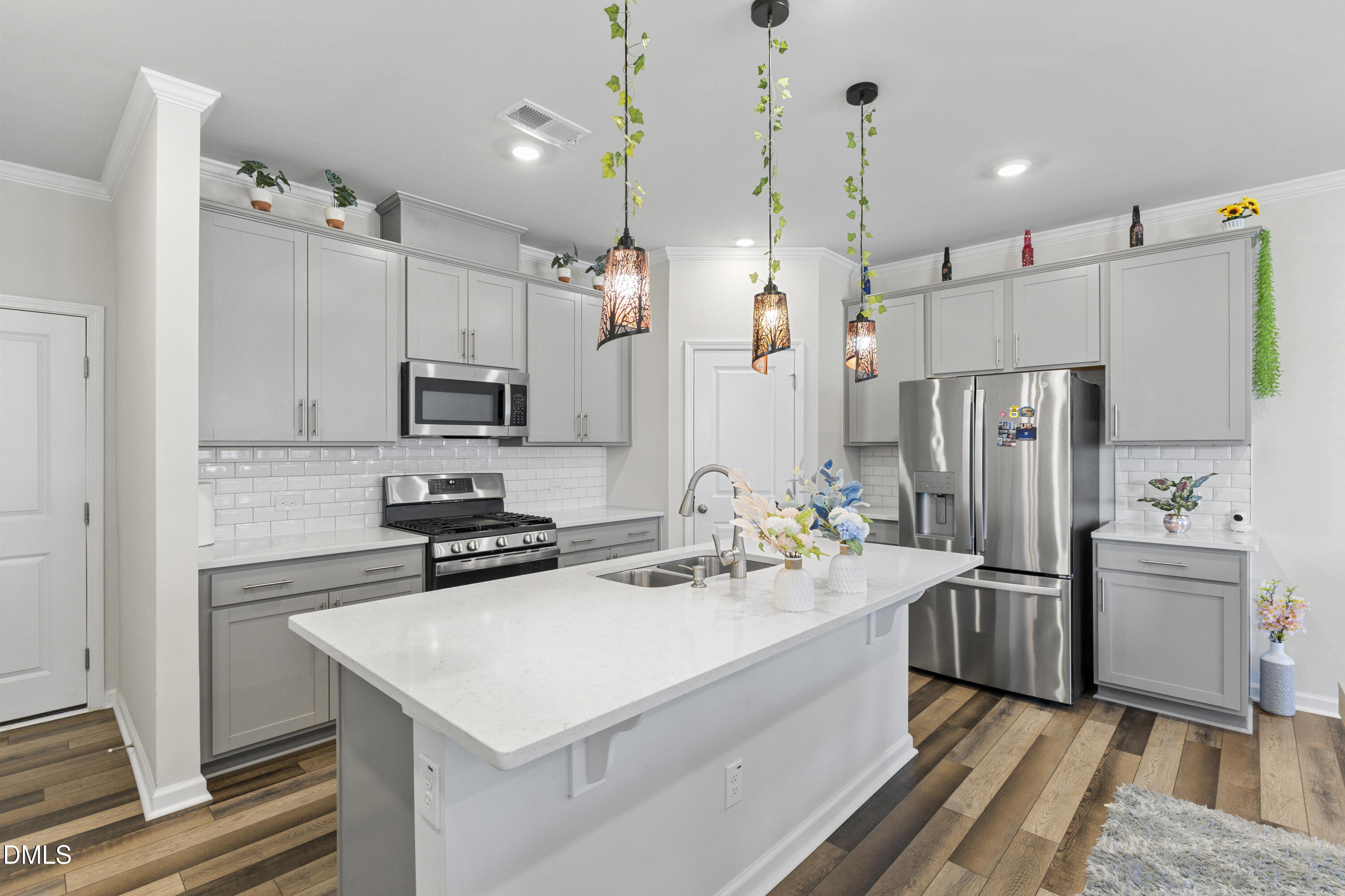 1811 Aspen River Lane Apex, NC 27502 - Photo 14 of 36 a kitchen with refrigerator cabinets and wooden floor