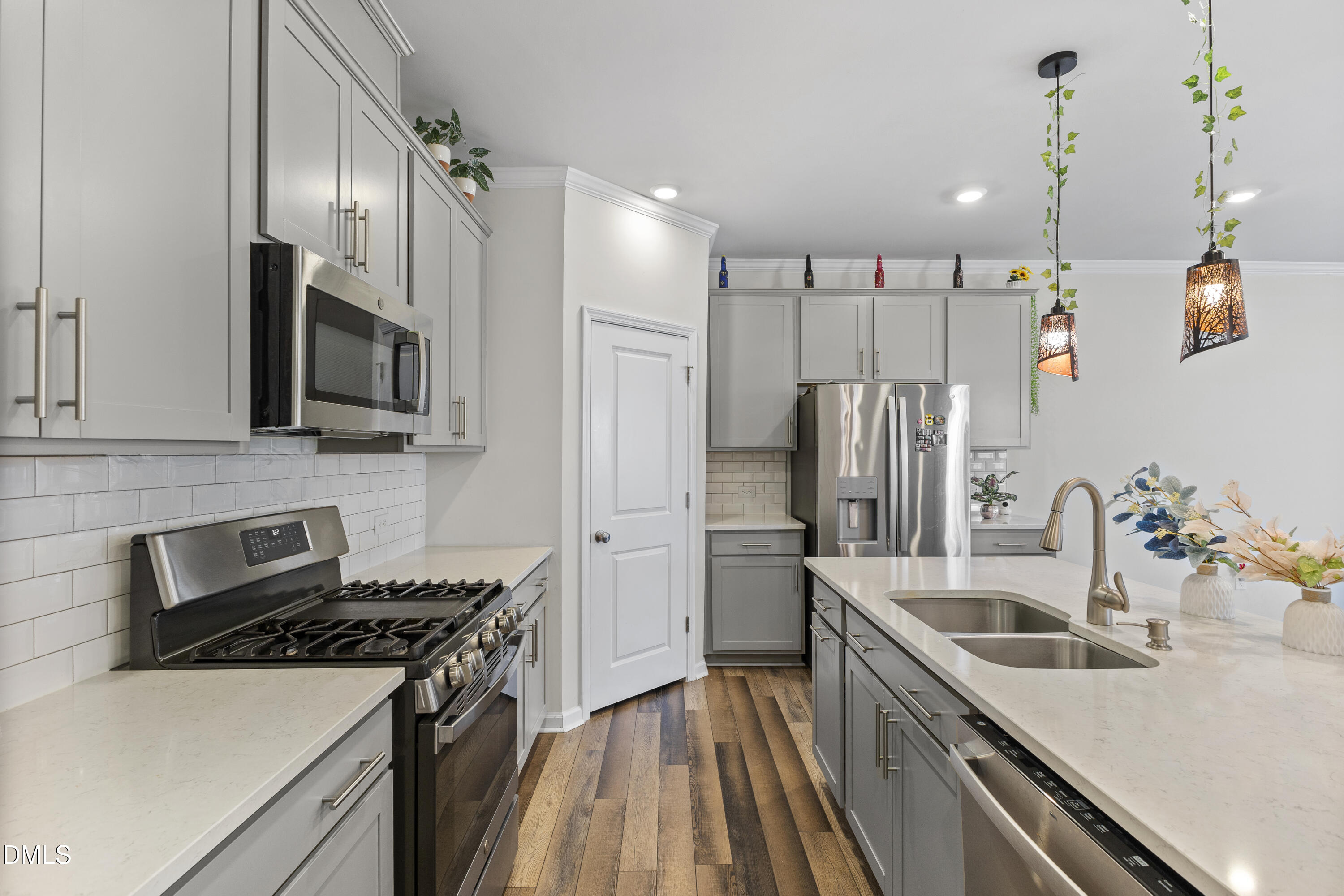 1811 Aspen River Lane Apex, NC 27502 - Photo 15 of 36 a kitchen that has a sink stainless steel appliances and cabinets