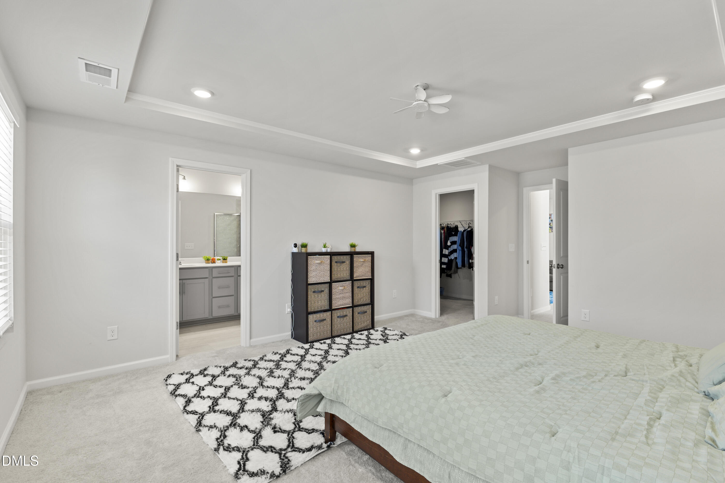 1811 Aspen River Lane Apex, NC 27502 - Photo 17 of 36 a bedroom with a bed and cabinets