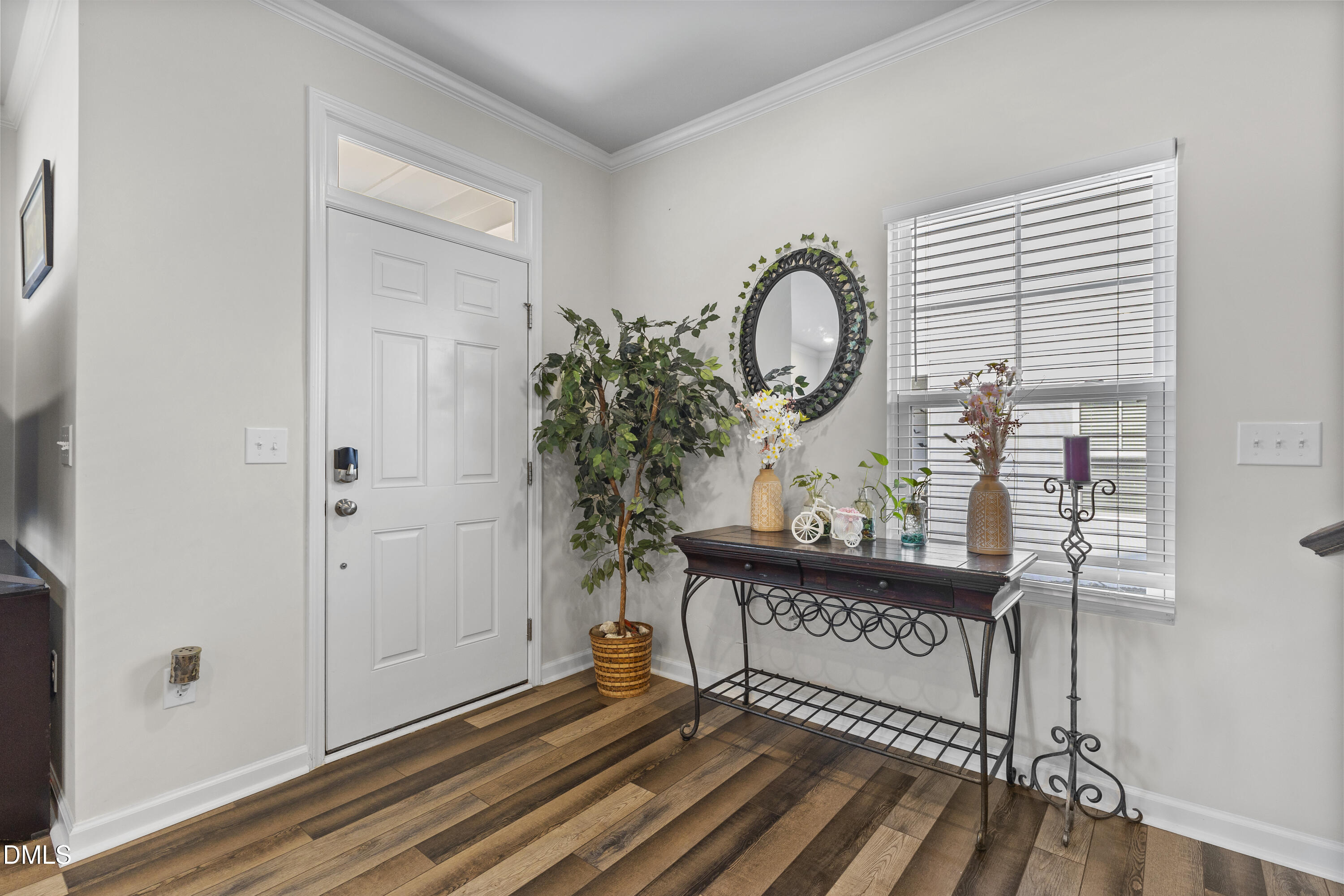 1811 Aspen River Lane Apex, NC 27502 - Photo 18 of 36 a view of a hallway with wooden floor and a potted plant