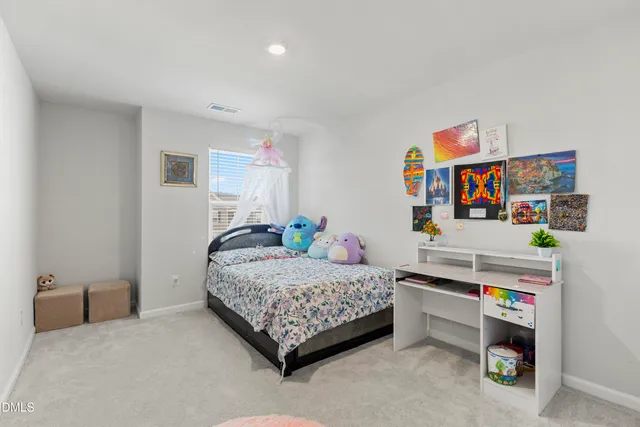 a bedroom with a bed and a desk