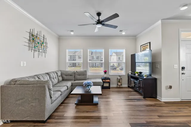 a living room with furniture and a view of bathroom