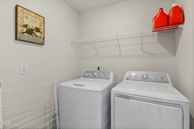 a view of a swimming pool with seating area and trees in the background