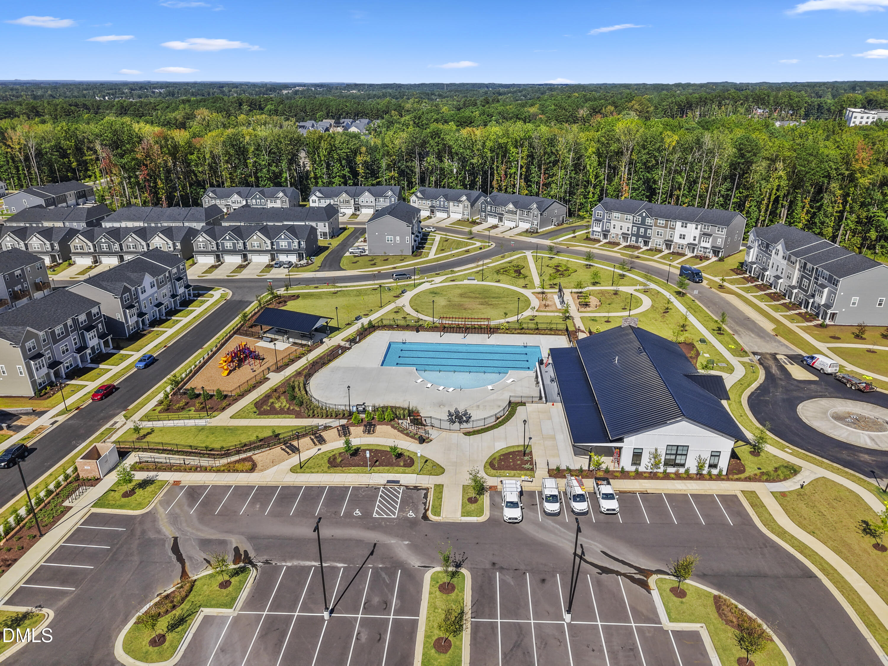1811 Aspen River Lane Apex, NC 27502 - Photo 28 of 36 a view of a swimming pool with seating area and trees in the background
