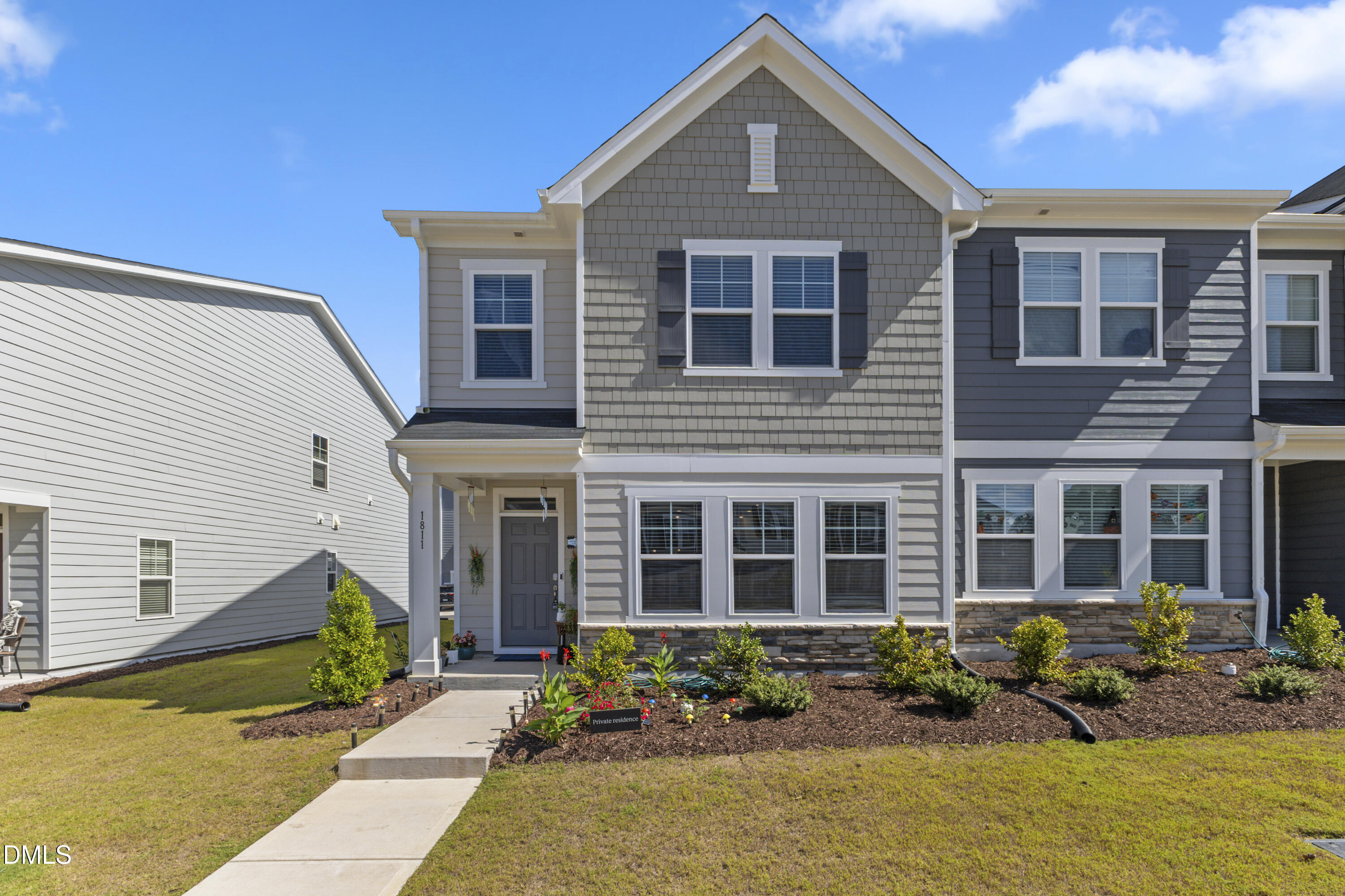 1811 Aspen River Lane Apex, NC 27502 - Photo 3 of 36 a front view of a house with lots of small garden