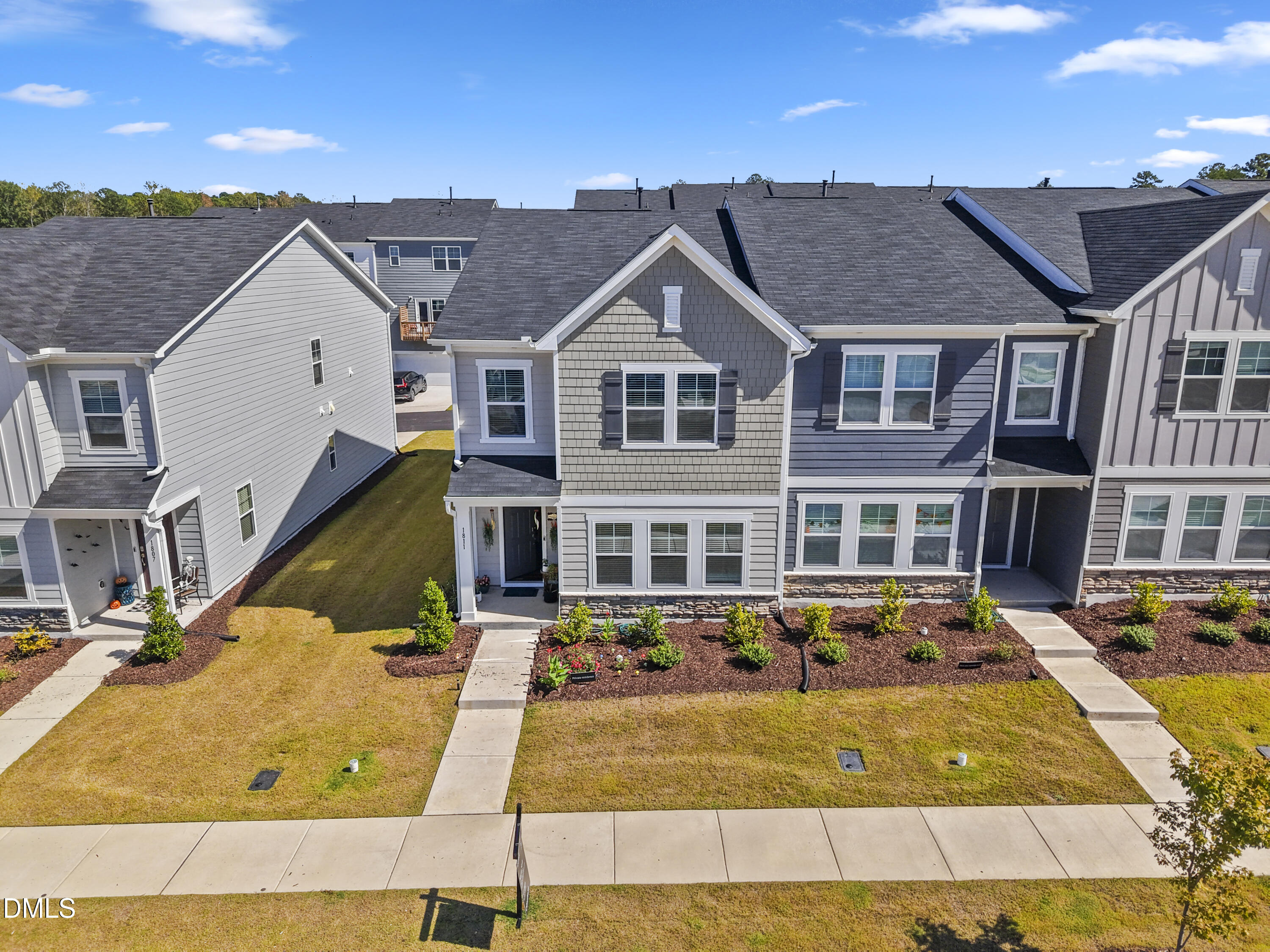 1811 Aspen River Lane Apex, NC 27502 - Photo 4 of 36 a view of a white house with a large pool next to a yard