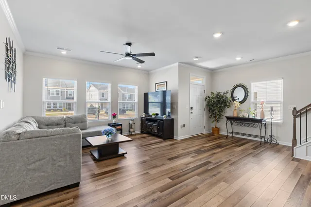 a kitchen with stainless steel appliances granite countertop a table chairs stove and refrigerator