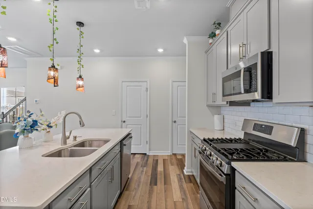 a kitchen with refrigerator cabinets and wooden floor