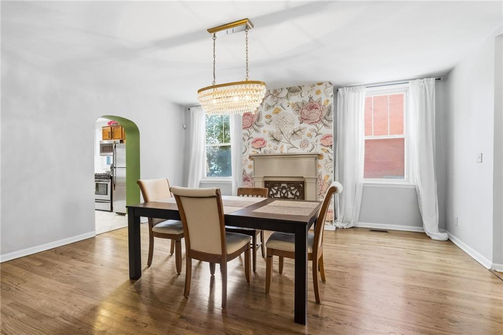 1311 Breed Street Pittsburgh, PA 15203 - Photo 11 of 44 a dining room with furniture a chandelier and wooden floor