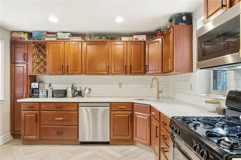 a kitchen with stainless steel appliances granite countertop a sink and cabinets