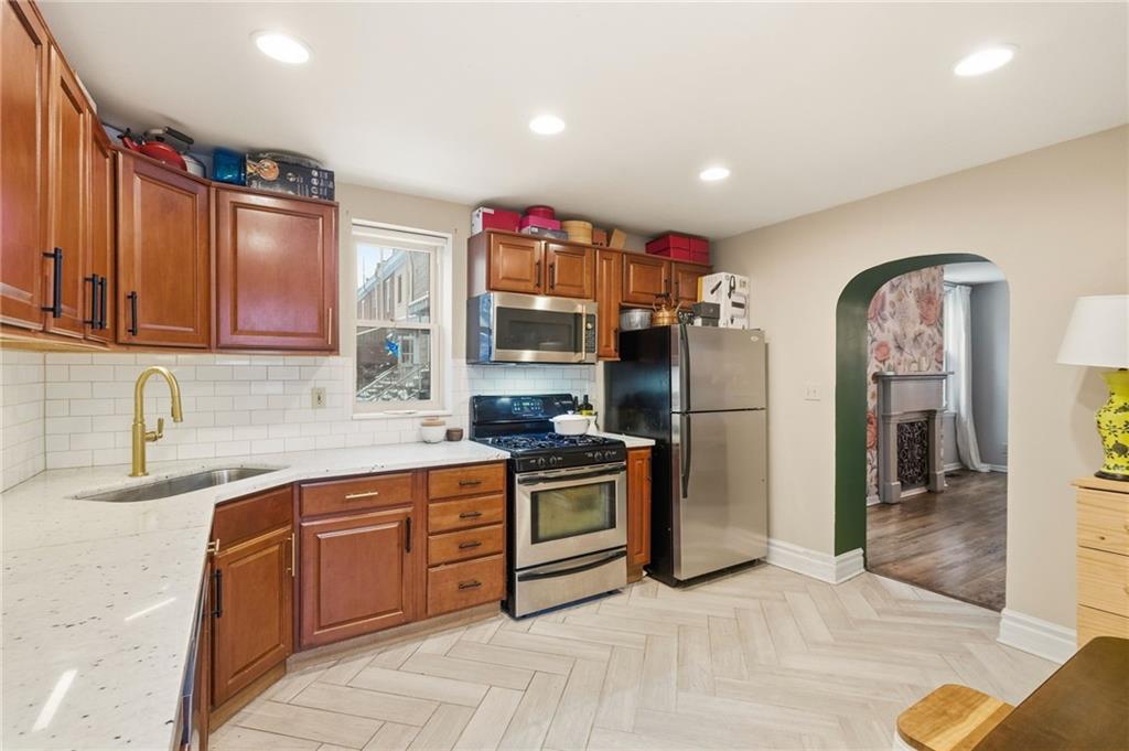 1311 Breed Street Pittsburgh, PA 15203 - Photo 15 of 44 a kitchen with stainless steel appliances granite countertop a sink and cabinets