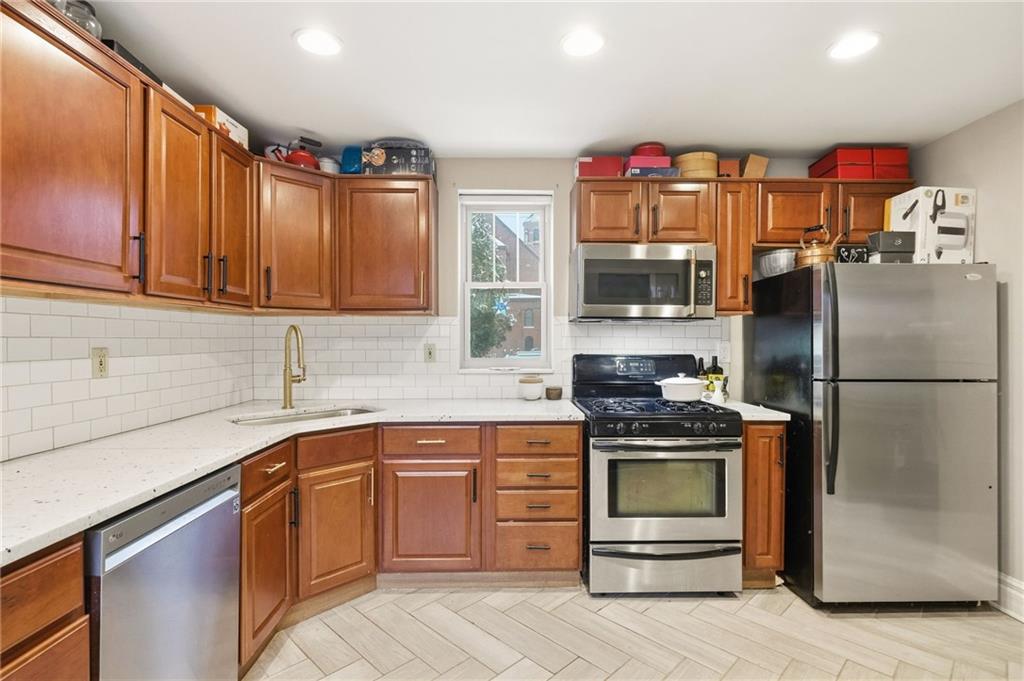 1311 Breed Street Pittsburgh, PA 15203 - Photo 16 of 44 a kitchen with stainless steel appliances granite countertop a refrigerator and a sink