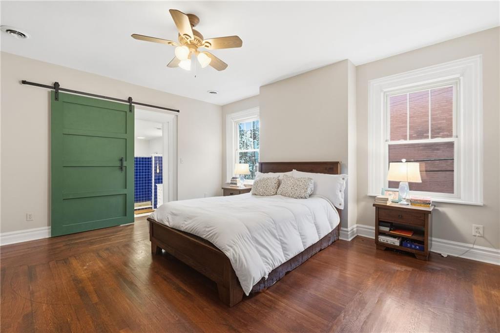 1311 Breed Street Pittsburgh, PA 15203 - Photo 22 of 44 a spacious bedroom with a bed and a chandelier