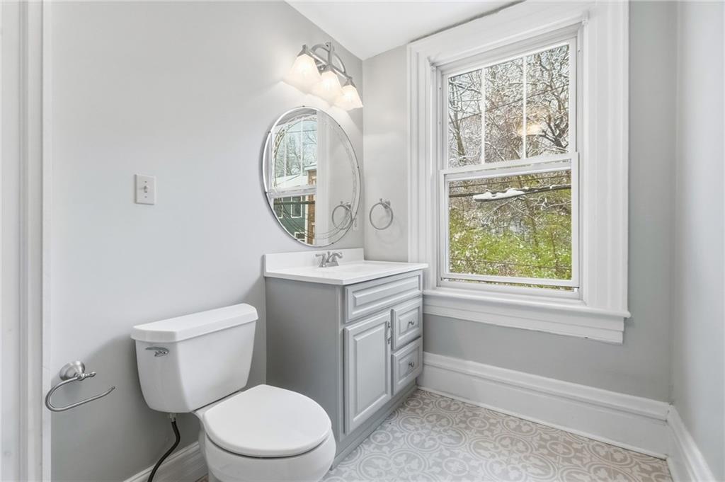 1311 Breed Street Pittsburgh, PA 15203 - Photo 27 of 44 a bathroom with a toilet a sink and a mirror