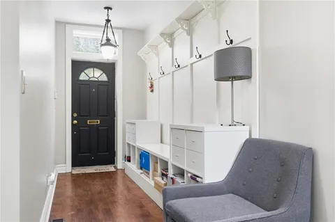 a living room with furniture a fireplace and a large window