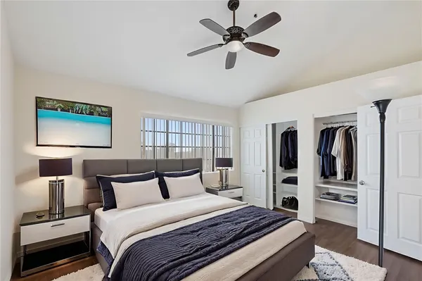a bedroom with a large bed and a chandelier
