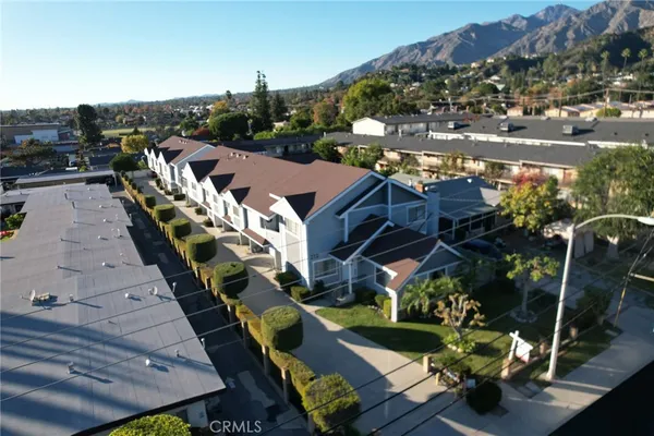 an aerial view of residential houses with outdoor space