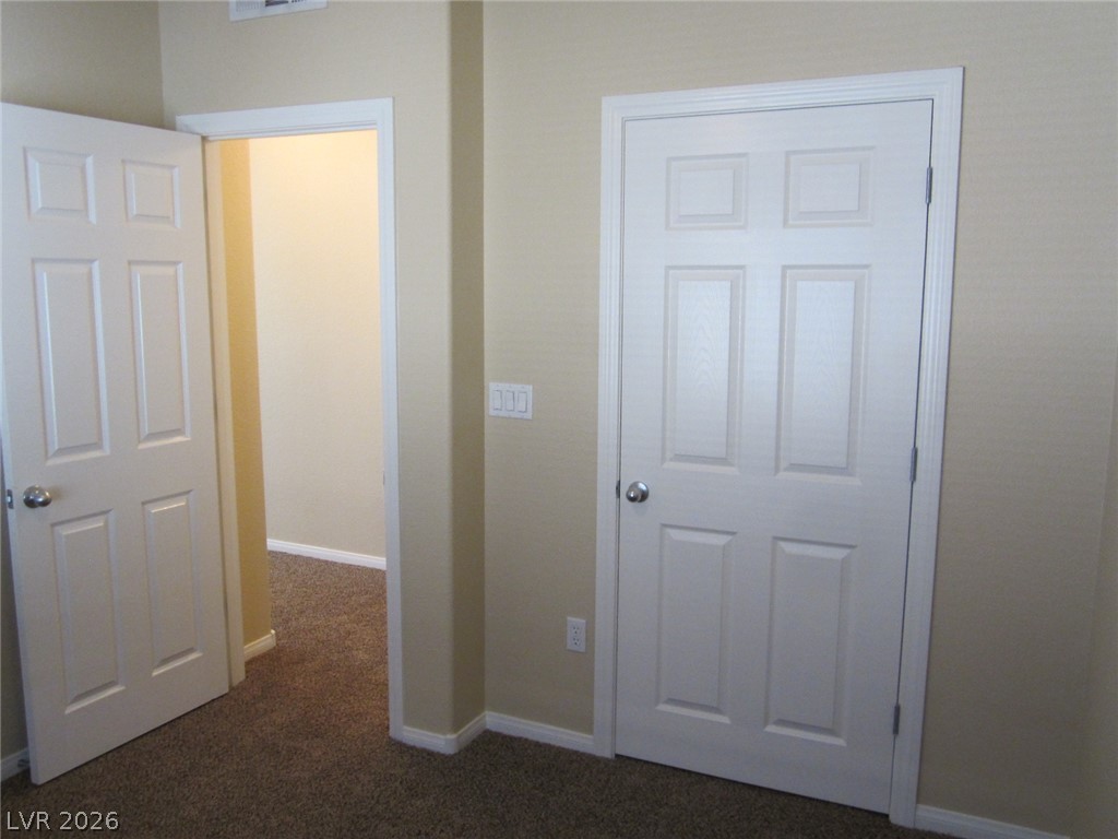7701 West Robindale Road, Unit 262 Las Vegas, NV 89113 - Photo 16 of 26 Textured carpet flooring leads to bright, clean-lined interior doorways.