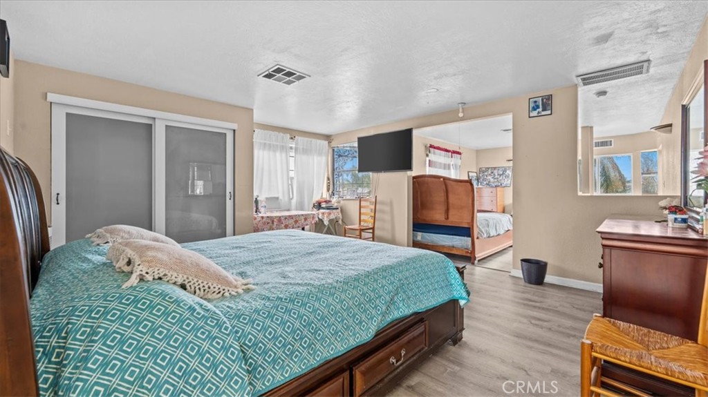 742 South Magnolia Avenue Rialto, CA 92376 - Photo 11 of 19 a bedroom with a bed and wooden floor