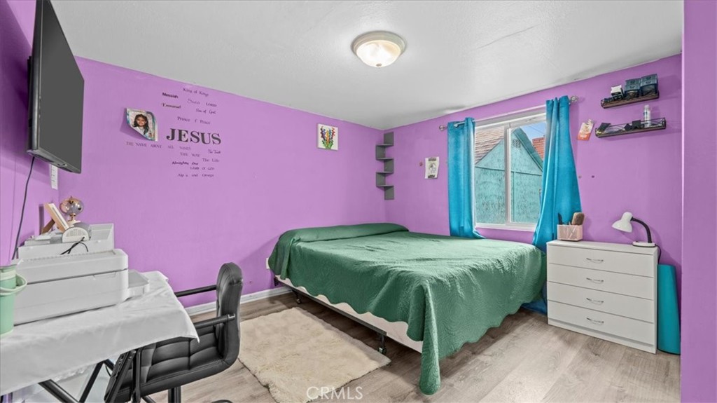 742 South Magnolia Avenue Rialto, CA 92376 - Photo 14 of 19 a bedroom with a bed and a dresser