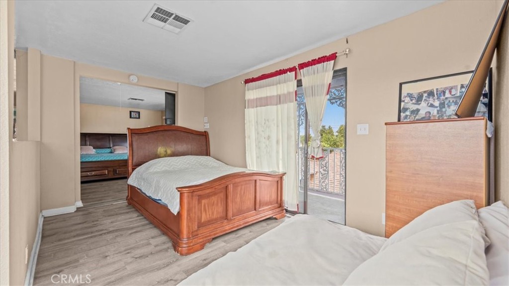 742 South Magnolia Avenue Rialto, CA 92376 - Photo 15 of 19 a bedroom with a bed and a painting on the wall