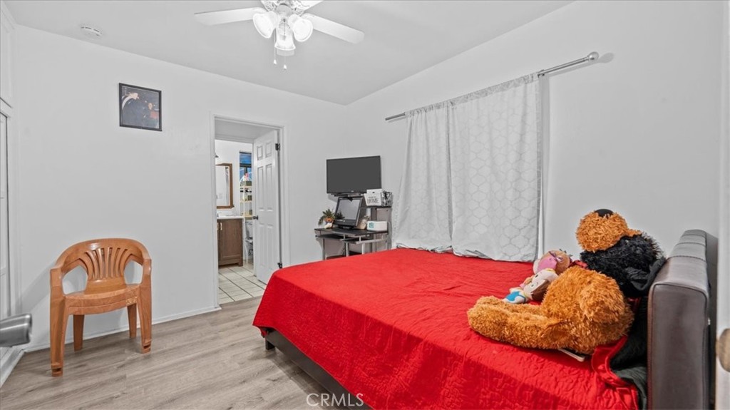 742 South Magnolia Avenue Rialto, CA 92376 - Photo 3 of 19 a bedroom with a bed and a chandelier