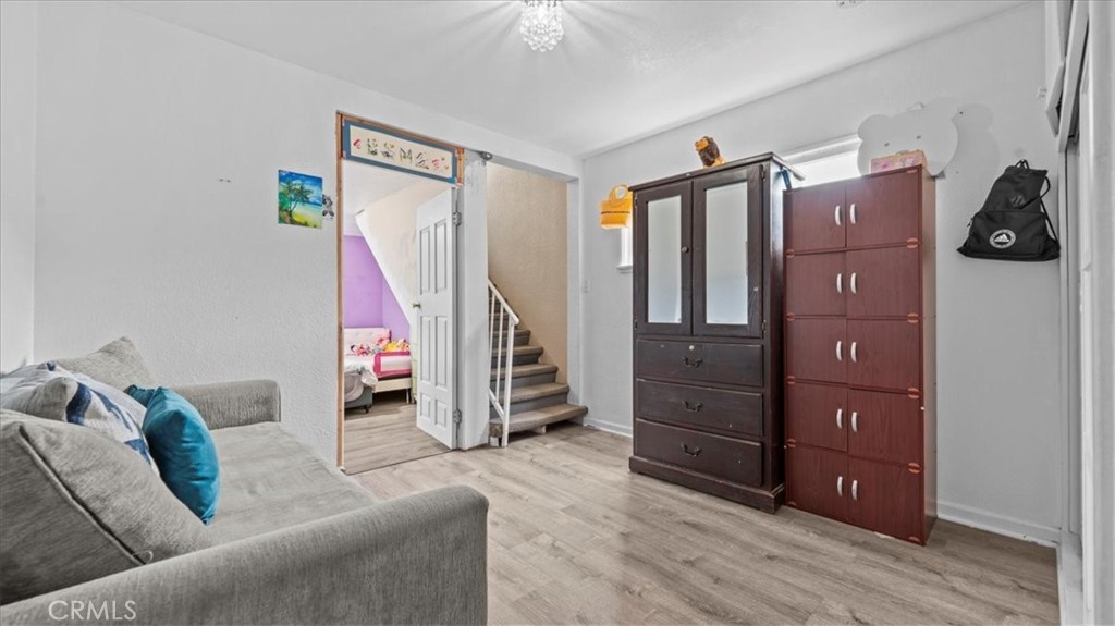 742 South Magnolia Avenue Rialto, CA 92376 - Photo 9 of 19 a living room with furniture and a wooden floor
