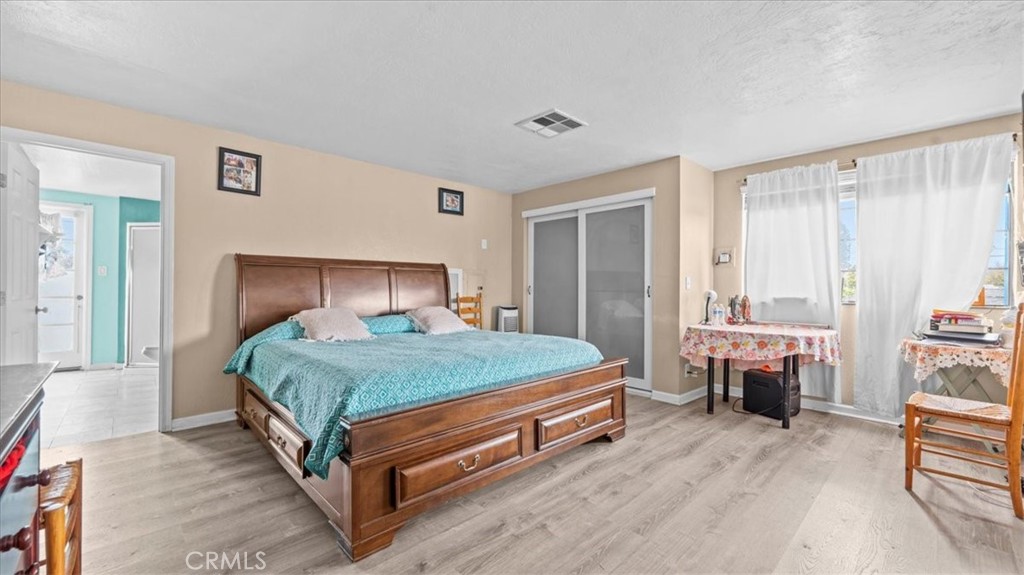 742 South Magnolia Avenue Rialto, CA 92376 - Photo 10 of 19 a bedroom with a bed and a couch