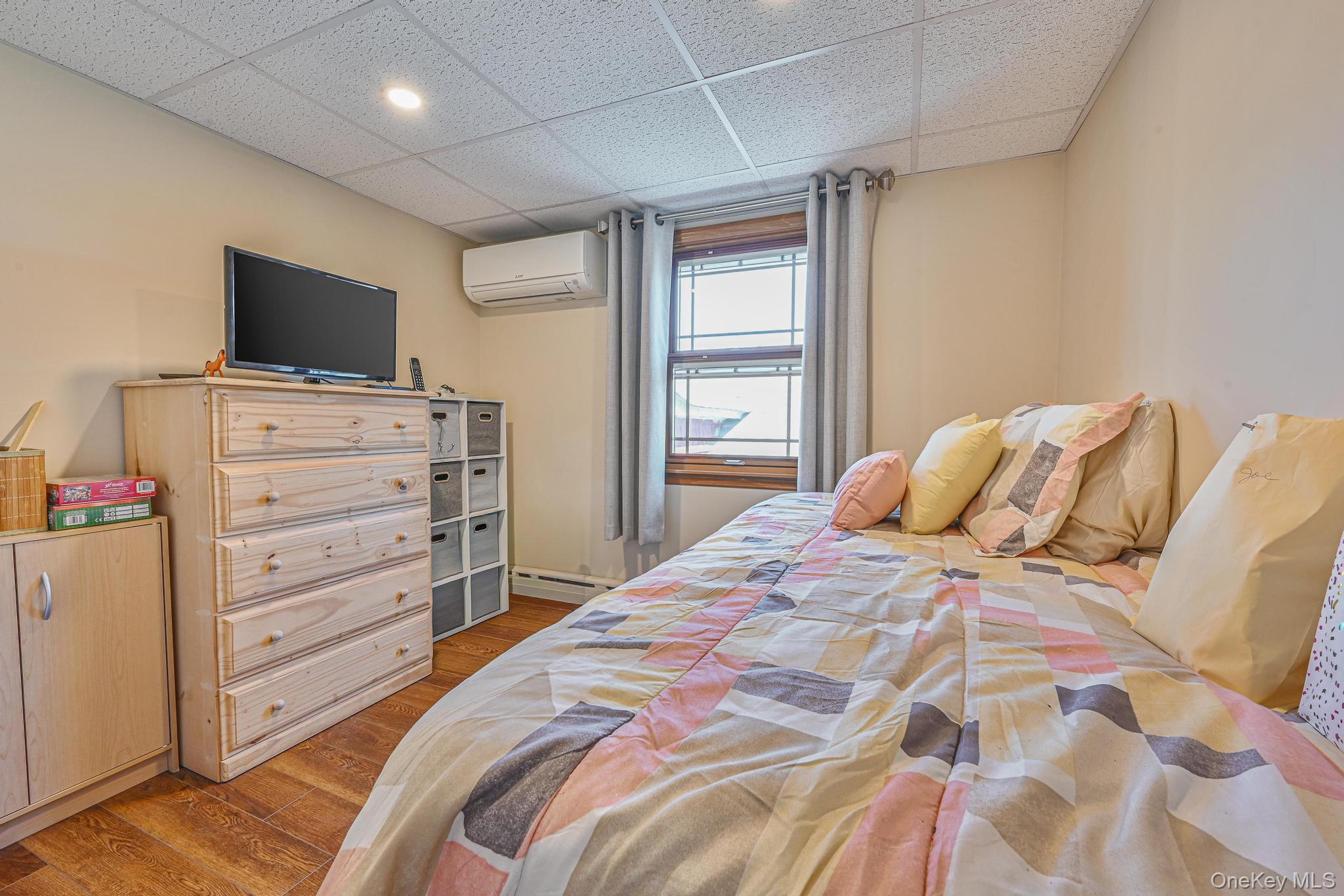 20 West 18th Road Queens, NY 11693 - Photo 31 of 41 a bedroom with a bed and a flat screen tv