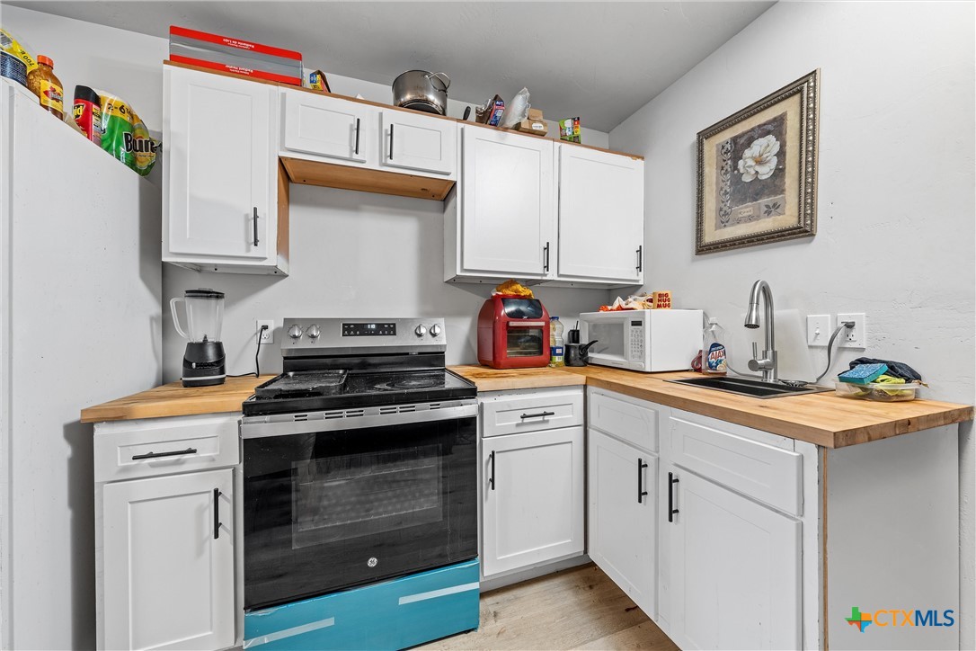 1211 South 17th Street Temple, TX 76504 - Photo 17 of 21 a kitchen with cabinets appliances and a sink