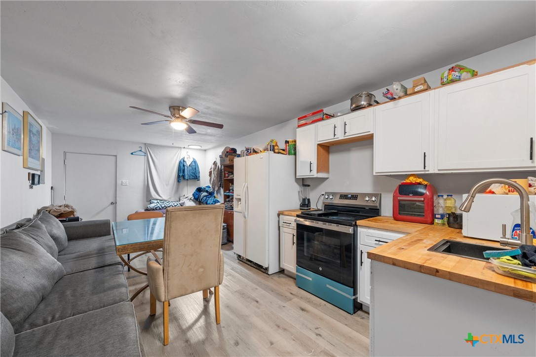 1211 South 17th Street Temple, TX 76504 - Photo 18 of 21 a living room with furniture and kitchen view