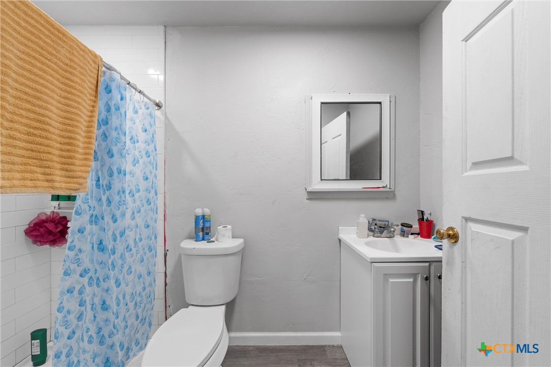 1211 South 17th Street Temple, TX 76504 - Photo 19 of 21 a bathroom with a sink toilet and a mirror