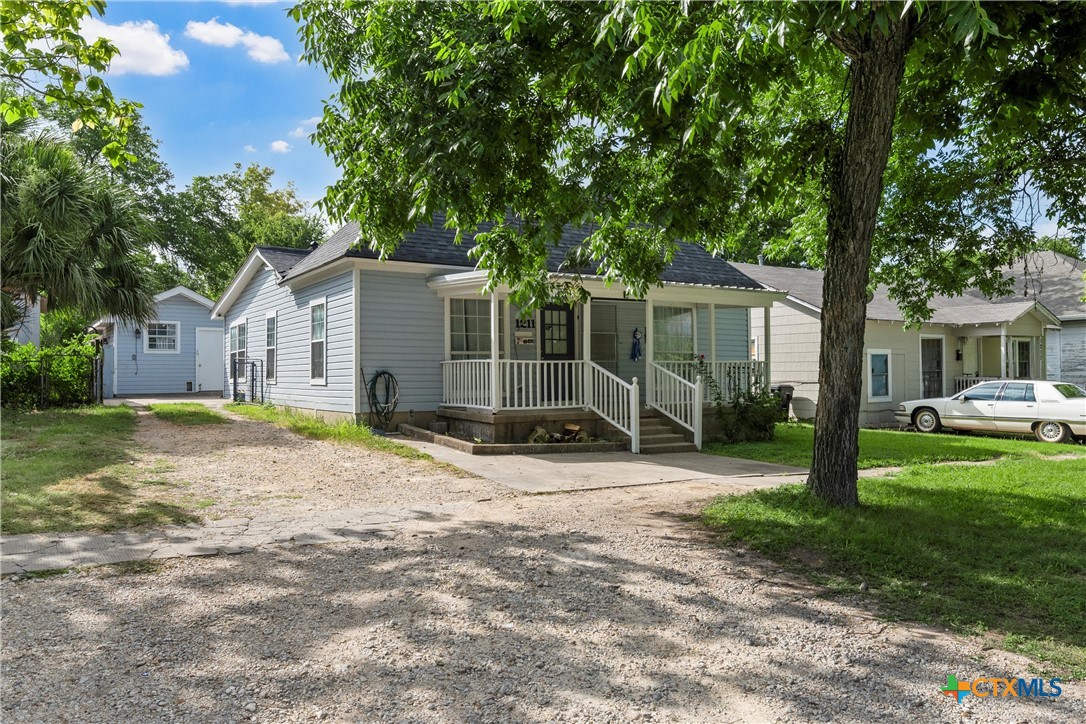 1211 South 17th Street Temple, TX 76504 - Photo 2 of 21 a view of a house with backyard and a tree