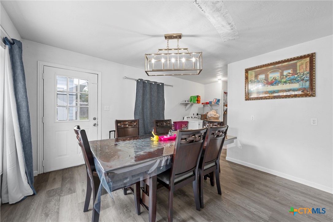 1211 South 17th Street Temple, TX 76504 - Photo 7 of 21 a view of a dining room with furniture a chandelier and wooden floor