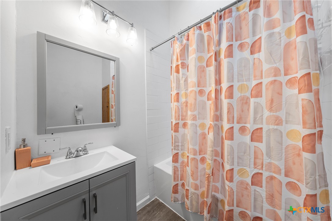 1211 South 17th Street Temple, TX 76504 - Photo 9 of 21 a bathroom with a sink and a mirror