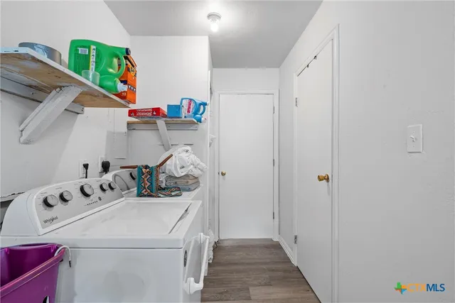 a bedroom with a bed dresser and flat screen tv